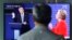A man watches a TV screen showing the live broadcast of the U.S. presidential debate between Democratic presidential candidate Hillary Clinton and Republican presidential candidate Donald Trump, at Seoul Railway Station in Seoul, South Korea, Sept. 27, 20
