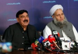 Pakistan's Interior Minister Sheikh Rashid Ahmad, left, and Religious Affairs Minister Noor-ul-Haq Qadri, give a press conference addressing anti-France violence, in Islamabad, April 15, 2021.