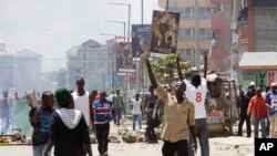 FILE - Opposition supporters clash with police in the Jacaranda grounds quarter in Nairobi, Kenya, Nov. 28, 2017.