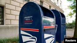 FILE - A Priority Mail Express collection bin is seen near the Trump International Hotel in Washington, Aug. 22, 2020. 