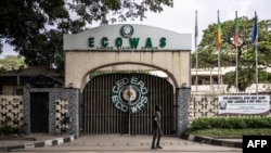 FILE - A local resident walks past the Economic Community of West African States (ECOWAS) office in Lagos, Nigeria, Sept. 24, 2024.