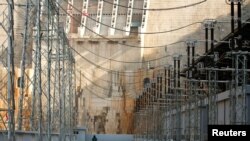 FILE - A man walks within the Gibe III hydroelectric dam during its inauguration in Shoma Yero village in Southern Nations, Nationalities, and Peoples' Region in Ethiopia, Dec. 17, 2016. 