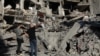 People stand on the rubble at the site of the Israeli airstrike that killed Lebanon's Hezbollah leader Sayyed Hassan Nasrallah on Friday, in Beirut's southern suburbs, Lebanon, Sept. 29, 2024. 