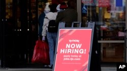 Hiring sign is displayed outside of a retail store in Vernon Hills, Ill., Nov. 13, 2021.