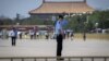 Police officers patrol and secure an area on Tiananmen Square in Beijing on June 3, 2019.