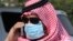 A man with mask speaks on his mobile phone in Jeddah, Saudi Arabia, May 29, 2014.