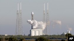 A Falcon 9 SpaceX rocket, stands ready at space launch complex 40, shortly before the launch was scrubbed because of a technical issue at the Cape Canaveral Air Force Station in Cape Canaveral, Fla., Dec. 18, 2018. 