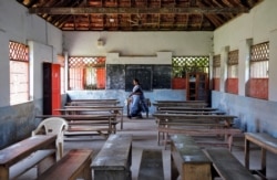 A staff member walks inside an empty classroom of a school after Kerala state government ordered the closure of schools across the state, amid coronavirus fears, in Kochi, India March 12, 2020.