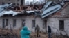 FILE - Residents walk at a site of a Russian missile strike in Dnipro, Nov. 21, 2025.