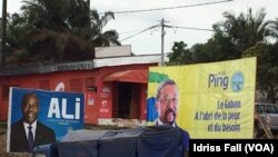 Les affiches de la campagne électorale du président gabonais sortant Ali Bongo et de son rival Jean Ping de l’opposition, sont côte-à-côte, à Libreville, 26 août 2016. VOA/Idriss Fall 