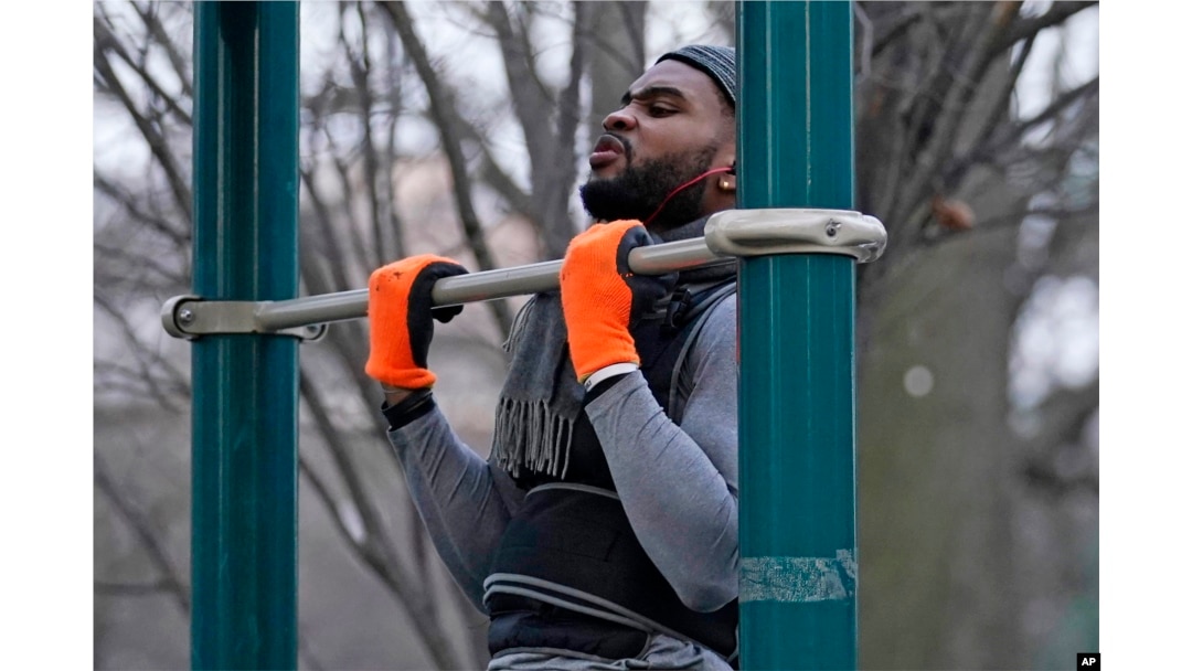 FILE - Zay Frection works out in "the gym" at Fort Greene Park, Thursday, Dec. 23, 2020, in the Brooklyn borough of New York. (AP Photo/Kathy Willens) Size:
