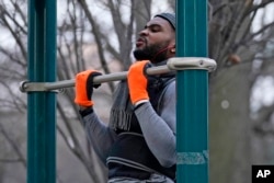 FILE - Zay Frection works out in "the gym" at Fort Greene Park, Thursday, Dec. 23, 2020, in the Brooklyn borough of New York. (AP Photo/Kathy Willens) Size: