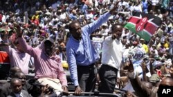 Kenya's former Education Minister William Ruto, center left, Kenya's Deputy Prime Minister Uhuru Kenyatta, center, and Kenya's Vice President Kalonzo Musyoka, center right, wave to thousands of people during a prayer rally at Uhuru Park, Kenya, Monday, Ap