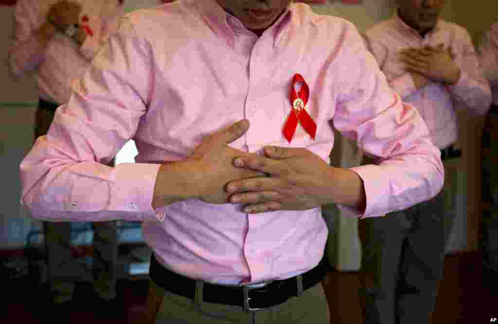 HIV-infected men, who volunteer to help other HIV patients, perform during a meeting with Red Cross officials at Ditan hospital in Beijing, November 30, 2012, the eve of World AIDS Day. An estimated 780,000 people live with HIV in China.