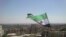 An opposition flag is seen over neighborhood Ruknuddin in Damascus August 5, 2012. Picture taken August 5, 2012. REUTERS/Shaam News Network/Handout (SYRIA - Tags: POLITICS CIVIL UNREST) FOR EDITORIAL USE ONLY. NOT FOR SALE FOR MARKETING OR ADVERTISING CAM