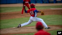 FILE - Cuba's pitcher Yoanni Yera Montalvo throws the ball during a training session at the Estadio Latinoamericano in Havana, Cuba, May 18, 2021. 