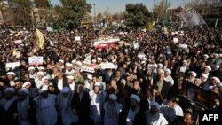 Pro-government demonstrators hold banners during a march in the central Iranian city of Isfahan, Jan. 4, 2018. 