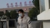 A man leaves the Wuhan Medical Treatment Centre, where a man who died from a respiratory illness was confined, in the city of Wuhan, Hubei province.