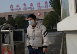 A man leaves the Wuhan Medical Treatment Centre, where a man who died from a respiratory illness was confined, in the city of Wuhan, Hubei province, on January 12, 2020.