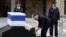 Israel's President Shimon Peres (C) lays a wreath near the flag draped coffin of former Israeli prime minister Ariel Sharon as he lies in state at the Knesset, Israel's parliament, in Jerusalem, Jan. 12, 2014. 