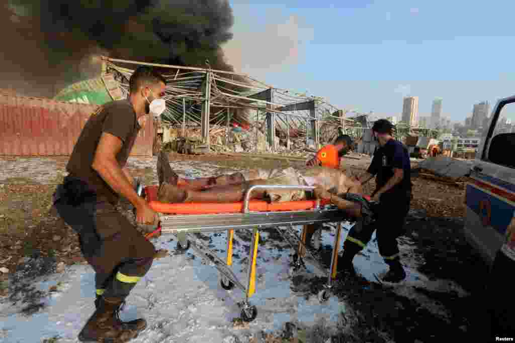 An injured man is transported on a stretcher following an explosion in Beirut, Lebanon, Aug. 4, 2020. 