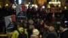 FILE - People hold up banners with images of U.S. President Donald Trump as they rally against his attendance of the Davos World Economic Forum, in central Zurich, Switzerland, Jan. 23, 2018. A Socialist youth group has been authorized Thursday to hold a similar rally in Davos.