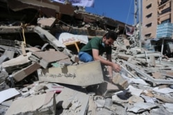 Palestinian Shaban Esleem inspects the rubbles of his bookstore which was destroyed in Israeli airstrikes during the Israeli-Palestinian fighting, in Gaza City, May 24, 2021.