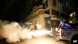 Workers in personal protective equipment sanitize a street in the wake of a spike in the number of positive coronavirus cases, in downtown Guatemala City, July 1, 2021.