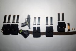 This photo provided by the Santa Clara County (Calif.) Sheriff's Office shows guns and ammunition magazines found at the residence of Samuel Cassidy, the suspect in the May 26, 2021, shooting at a San Jose rail station.