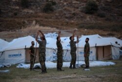 Greek soldiers set up UNHCR tents to accommodate asylum seekers left without shelter after fires at a refugee camp on Lesbos Island, Greece, Sept. 11, 2020.