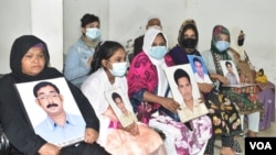 Members of families of enforced disappearances with the photos of the disappeared victims at a press briefing in Dhaka on January 15, 2022. At the press briefing, the families alleged that they are being hounded by the security agencies. (Photo, Badal Das)