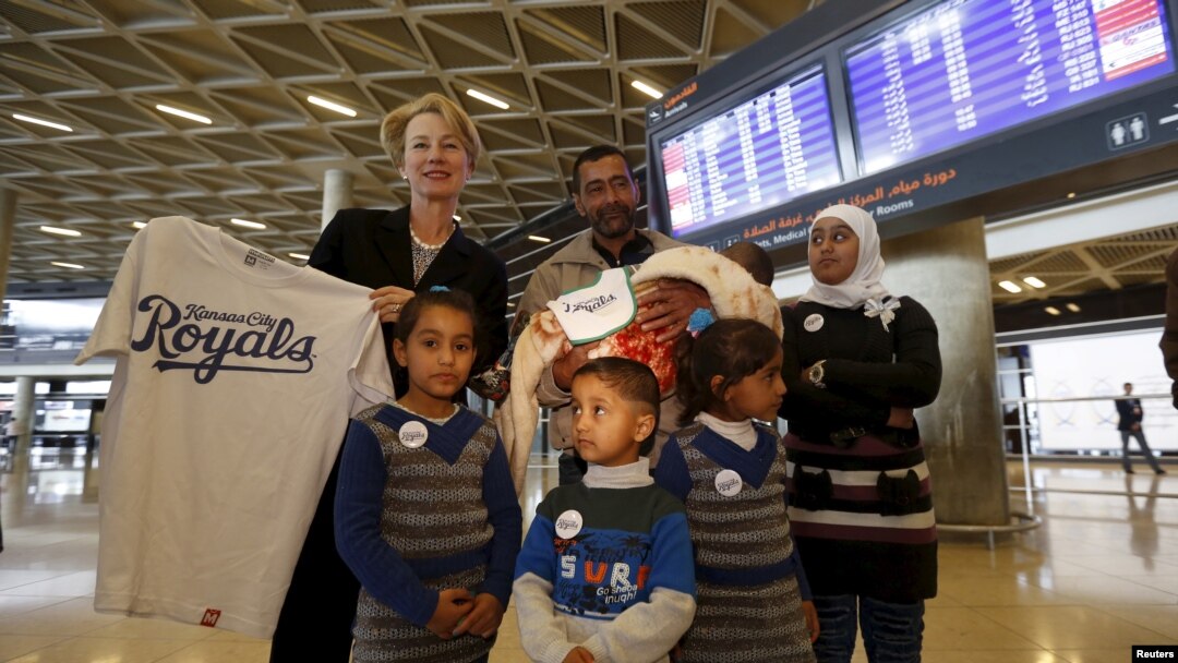 FILE - U.S Ambassador to Jordan Alice Wells,poses with the family of Syrian refugee Ahmad al Aboud, at the Queen Alia International Airport in Amman, Jordan, April 6, 2016. The family was headed for resettlement in the United States.