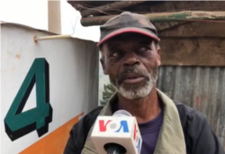 This man is not wearing a mask even though he knows he should. He says it takes getting used to and he finds it harder to breathe when he has it on. (Photo: Matiado Vilme / VOA)