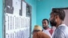 Voters check the voter list at a polling station in Mitsoudje on Jan. 12, 2025, during the Comorian parliamentary election. 