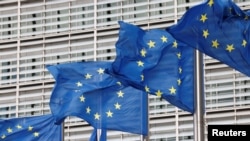 FILE: European Union flags flutter outside the EU Commission headquarters in Brussels. Taken September 28, 2022