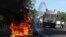 A police truck extinguishes a burning highway maintenance vehicle, after police dispersed protesters blocking a toll road and encouraging drivers not to pay, in Zambrano, north of Tegucigalpa, Honduras, Oct. 3, 2016. Groups organized by opposition political party LIBRE blocked major highways in multiple locations to protest against highway tolls.