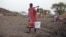 A woman carries water from a water hole near Jamam refugee camp in South Sudan's Upper Nile State, March 10, 2012.
