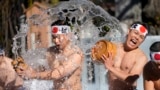 Shrine parishioners throw icy cold water on themselves during the annual cold-endurance festival at Kanda Myojin Shinto shrine in Tokyo, Jan. 18, 2025, a traditional Japanese way of purifying soul and praying for their health in the new year. 