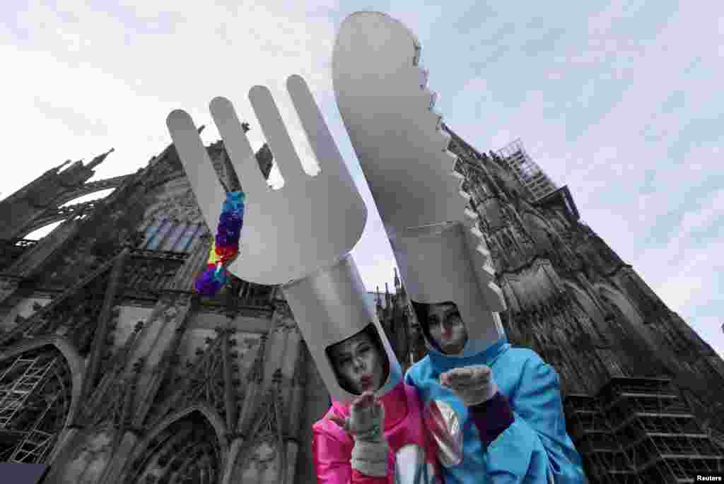 Women dressed in costumes for &quot;Weiberfastnacht&quot; (Women&#39;s Carnival) celebrate in front of Cologne&#39;s Cathedral, Germany.