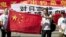 Chinese protesters hold banners reading "Declare war against Japan" and "Japan get out of Diaoyu islands" during a protest outside the Japanese Embassy in Beijing Aug. 15, 2012. 