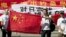 Chinese protesters hold banners reading "Declare war against Japan" and "Japan get out of Diaoyu islands" during a protest outside the Japanese Embassy in Beijing Aug. 15, 2012. 