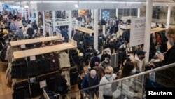 Shoppers walk at a store during Black Friday sales in the Manhattan borough of New York City, New York, U.S., Nov. 26, 2021. 