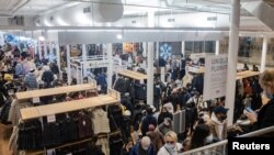 Shoppers walk at a store during Black Friday sales in the Manhattan borough of New York City, New York, U.S., Nov. 26, 2021. 