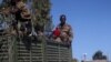 FILE - Ethiopian soldiers ride on a truck near the town of Adigrat, Tigray region, Ethiopia, March 18, 2021.