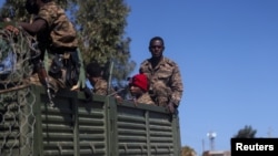 FILE - Ethiopian soldiers ride on a truck near the town of Adigrat, Tigray region, Ethiopia, March 18, 2021.