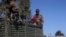 FILE - Ethiopian soldiers ride on a truck near the town of Adigrat, Tigray region, Ethiopia, March 18, 2021.