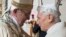 FILE - Pope Francis, left, and Pope Emeritus Benedict XVI hug at a Vatican ceremony, Dec. 8, 2015. Benedict shares his thoughts on the papacy in a new book, 'The Last Conversations.'