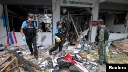 Security personnel inspect the Kok Po district office after being attacked by a group of gunmen in Pattani province, south of Bangkok, Sept. 11, 2014. 