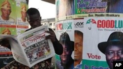 A man reads a local newspaper in Lagos, April 3, 2011