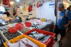 A shopper looks at seafood displayed for sale at a wet market in Singapore on Feb. 18, 2020.